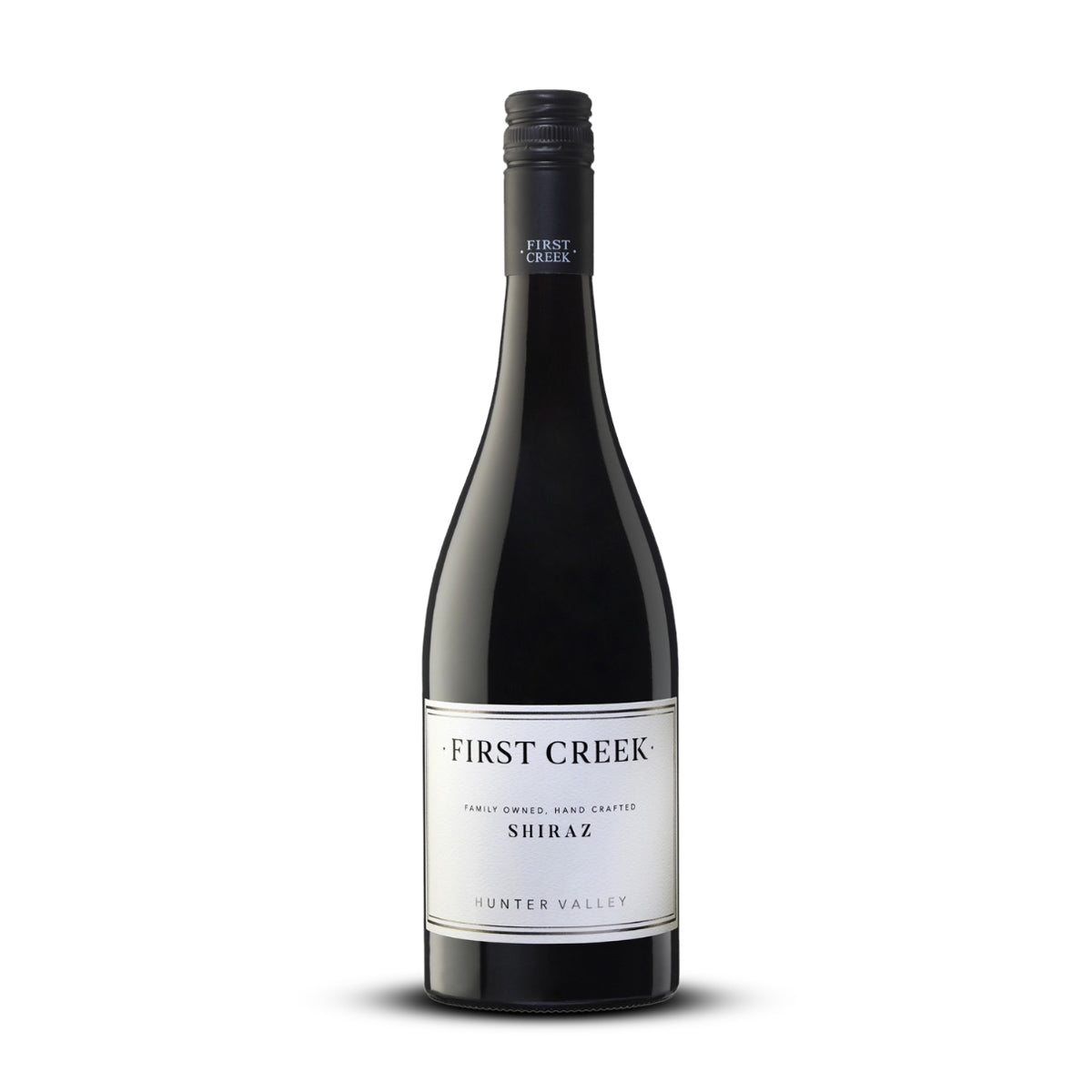 Red wine bottle labeled 'First Creek Shiraz' on a white background