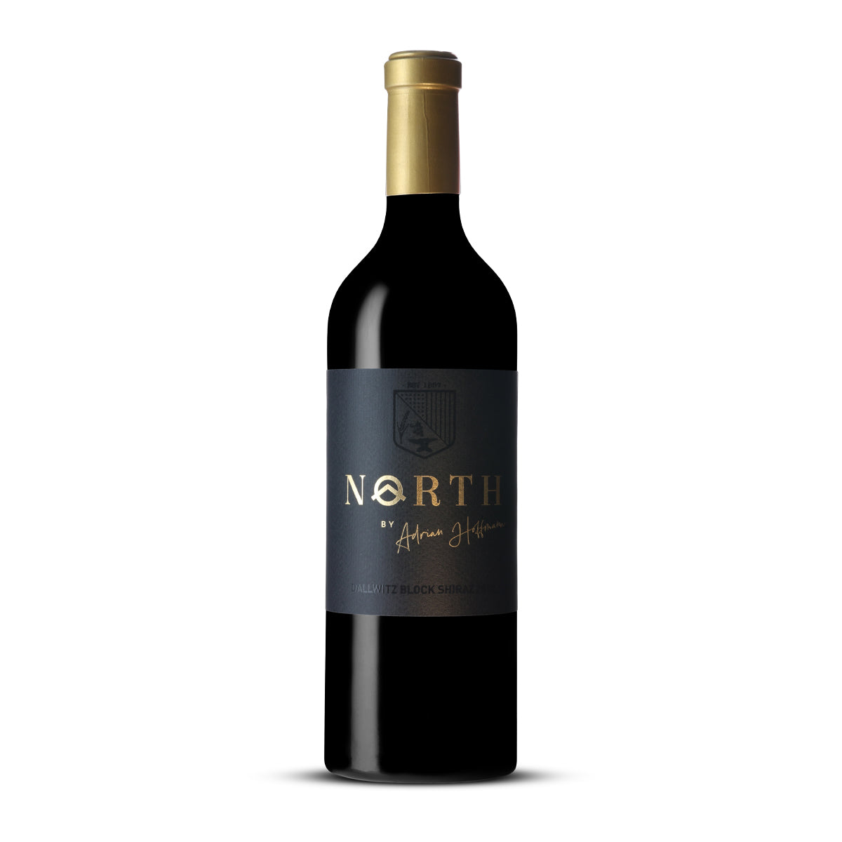Wine bottle labeled 'NORTH' on a white background by Adrian Hoffmann. 2018. Label is black with the words in Gold Foil fint.